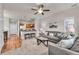 Comfortable living room features hardwood floors, a gray sofa set, and an open view of the kitchen at 3372 Central Park Blvd, Denver, CO 80238
