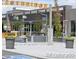 Inviting outdoor retail entrance with planters, seating area, and convenient access at 3372 Central Park Blvd, Denver, CO 80238