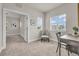 Well-lit sitting room showcases neutral colors, a window, and an open doorway leading to another room at 3372 Central Park Blvd, Denver, CO 80238