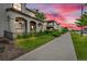 Street view looking down a street of homes with lush green lawns at 3372 Central Park Blvd, Denver, CO 80238