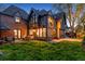 Stunning brick home at twilight, featuring a large backyard and inviting patio at 10 Cherry St, Denver, CO 80220