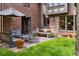 Brick home with outdoor dining and seating areas on the patio, perfect for entertaining at 10 Cherry St, Denver, CO 80220
