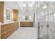 Luxurious bathroom featuring marble floors, dual vanities, and a glass-enclosed shower beneath skylights at 10 Cherry St, Denver, CO 80220