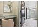 Bathroom vanity area leading to shower with tiled floor and glass partition at 10 Cherry St, Denver, CO 80220