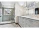 Bathroom with double vanity and step-in shower with gray tiled surround at 10 Cherry St, Denver, CO 80220
