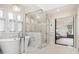 Luxurious bathroom featuring a freestanding tub, glass enclosed shower and marble finishes at 10 Cherry St, Denver, CO 80220