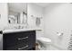 Bathroom featuring a dark vanity with gold hardware and a tiled floor at 10 Cherry St, Denver, CO 80220