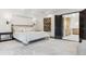 Spacious bedroom with neutral decor and an ensuite bathroom with lots of light at 10 Cherry St, Denver, CO 80220