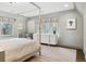 Sun-filled bedroom featuring large windows with decorative shades and ensuite seating at 10 Cherry St, Denver, CO 80220