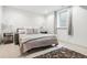 Bedroom featuring a comfortable bed with decorative pillows and a side table at 10 Cherry St, Denver, CO 80220