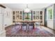 Elegant dining room with large windows, a modern chandelier, and custom built-in cabinetry at 10 Cherry St, Denver, CO 80220