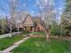 Charming brick Tudor home featuring a beautiful lawn and mature trees at 10 Cherry St, Denver, CO 80220