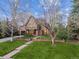 Charming Tudor-style home with well-kept front yard and stone pathway leading to the front door at 10 Cherry St, Denver, CO 80220