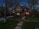 Stunning brick home with a well-manicured lawn and inviting walkway at dusk at 10 Cherry St, Denver, CO 80220
