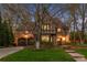 Charming Tudor-style home featuring a brick facade, arched doorways, a well-manicured lawn, and an attached two-car garage at 10 Cherry St, Denver, CO 80220