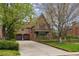 Brick home with arched garage doors and driveway with basketball hoop at 10 Cherry St, Denver, CO 80220