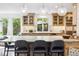 Spacious kitchen with a large marble-top island and bar seating beneath modern pendant lighting at 10 Cherry St, Denver, CO 80220