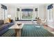 Living room features a window seat, marble table and a bold area rug at 10 Cherry St, Denver, CO 80220