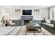 Bright living room featuring a decorative fireplace, modern furnishings, and custom built-ins at 10 Cherry St, Denver, CO 80220