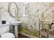 Charming powder room with bird-themed wallpaper, oval mirror, and pedestal sink at 10 Cherry St, Denver, CO 80220