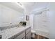 Bathroom with granite countertop, gray cabinets, and a shower/tub combo at 45008 Sunflower Ln, Bennett, CO 80102