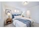 Main bedroom with neutral decor, nightstands and en-suite bathroom at 45008 Sunflower Ln, Bennett, CO 80102