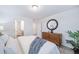 Bedroom with dresser, en-suite bathroom access, and neutral decor at 45008 Sunflower Ln, Bennett, CO 80102