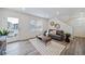 Bright and airy living room with hardwood floors, modern furniture and balcony access at 45008 Sunflower Ln, Bennett, CO 80102