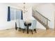 Elegant dining area with plush blue chairs, hardwood floors, and a modern chandelier fixture at 3924 Alamosa Ct, Brighton, CO 80601