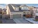 Charming two-story home with a neutral exterior, attached garage, and stone accents at 3924 Alamosa Ct, Brighton, CO 80601