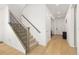 Hallway features wood floors and stairs with decorative iron railing at 3924 Alamosa Ct, Brighton, CO 80601