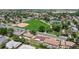 Scenic aerial perspective of a house close to a baseball field, tennis courts, and open green space in a residential area at 235 N 12Th Ave, Brighton, CO 80601