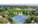 An aerial shot showcases the house next to a scenic park with a baseball field, playground, and tennis courts at 235 N 12Th Ave, Brighton, CO 80601