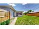 Lovely backyard with a covered screened in sunroom and newer wooden fence at 235 N 12Th Ave, Brighton, CO 80601