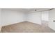 Spacious, finished basement with soft carpet and crisp white walls leads to other rooms at 235 N 12Th Ave, Brighton, CO 80601