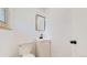 Powder room with sleek vanity, mirror, and toilet at 235 N 12Th Ave, Brighton, CO 80601