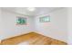 A bright bedroom featuring hardwood floors and natural light from two windows at 235 N 12Th Ave, Brighton, CO 80601
