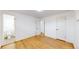Bedroom with hardwood floors leading to the bathroom at 235 N 12Th Ave, Brighton, CO 80601