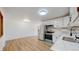 Updated kitchen with stainless steel appliances, white cabinets, modern backsplash, and modern sink at 235 N 12Th Ave, Brighton, CO 80601