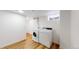 Functional laundry area equipped with washer, dryer, and hardwood flooring at 235 N 12Th Ave, Brighton, CO 80601
