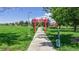 Serene park scene featuring a walking path, vibrant red Torii gate, and shaded picnic area at 235 N 12Th Ave, Brighton, CO 80601