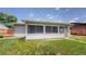 Enclosed sunroom with screens overlooks the backyard, offering a tranquil space at 235 N 12Th Ave, Brighton, CO 80601