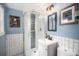 Bathroom featuring a modern glass shower, stylish fixtures, and elegant blue wall paint at 5672 Santa Clara Rd, Indian Hills, CO 80454