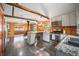 Kitchen and living space featuring wooden beams, stainless steel appliances, and a breakfast bar with seating at 5672 Santa Clara Rd, Indian Hills, CO 80454