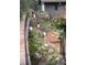 Beautiful, landscaped walkway with stone steps and potted flowers leading to the charming mountain home at 5672 Santa Clara Rd, Indian Hills, CO 80454