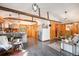 Open-concept living space featuring hardwood floors, wooden beams, and a stylish kitchen with stainless steel appliances at 5672 Santa Clara Rd, Indian Hills, CO 80454