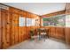Bright office space with wooden walls, neutral carpet, and window with natural lighting at 5672 Santa Clara Rd, Indian Hills, CO 80454