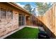 Enclosed backyard featuring artificial turf and a sliding door, creating a private and inviting outdoor area at 1501 E Panama Dr, Centennial, CO 80121