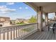 View from the balcony overlooking the street with neighboring houses and green lawns on a bright day at 7141 Red Mesa Dr, Littleton, CO 80125
