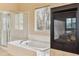 Bright bathroom with tub, shower and fireplace at 7141 Red Mesa Dr, Littleton, CO 80125